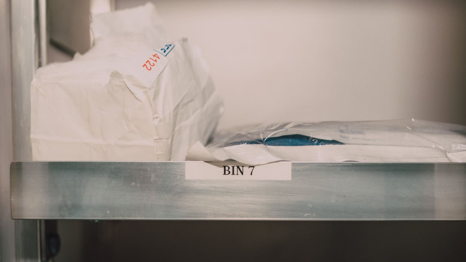 Medical supplies organised in labelled storage bins in a healthcare setting