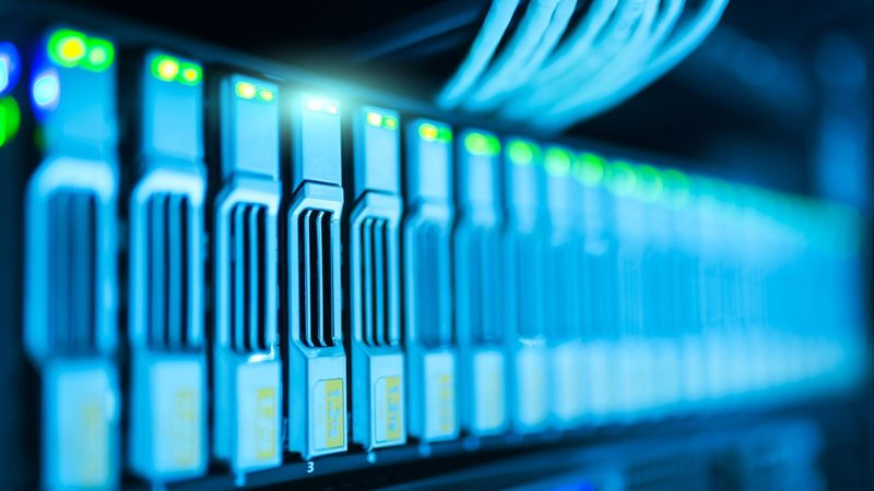 Close-up of server drive bays lit blue inside a rack