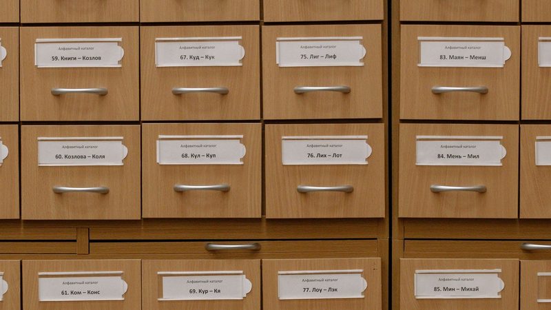 Rows of labelled binder folders holding technical records on a shelf