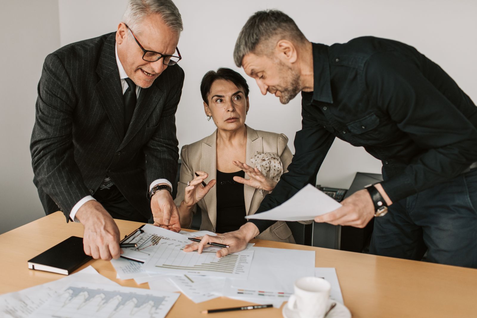 Procurement team working through sourcing documents around a table